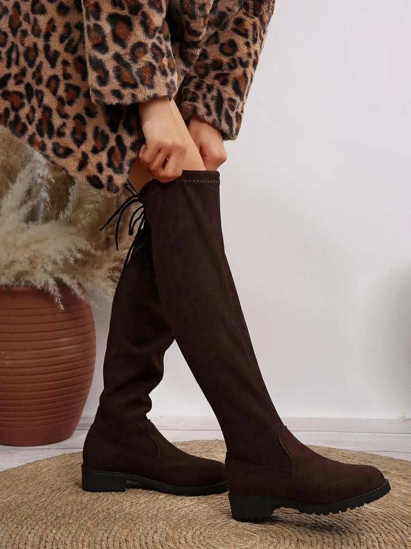 Chocolate brown lace-up knee-high boots with a low block heel
